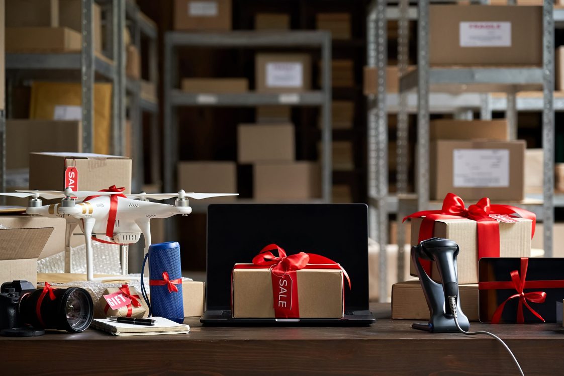 wrapped holiday packages sitting on a desk in the back of the shipping room