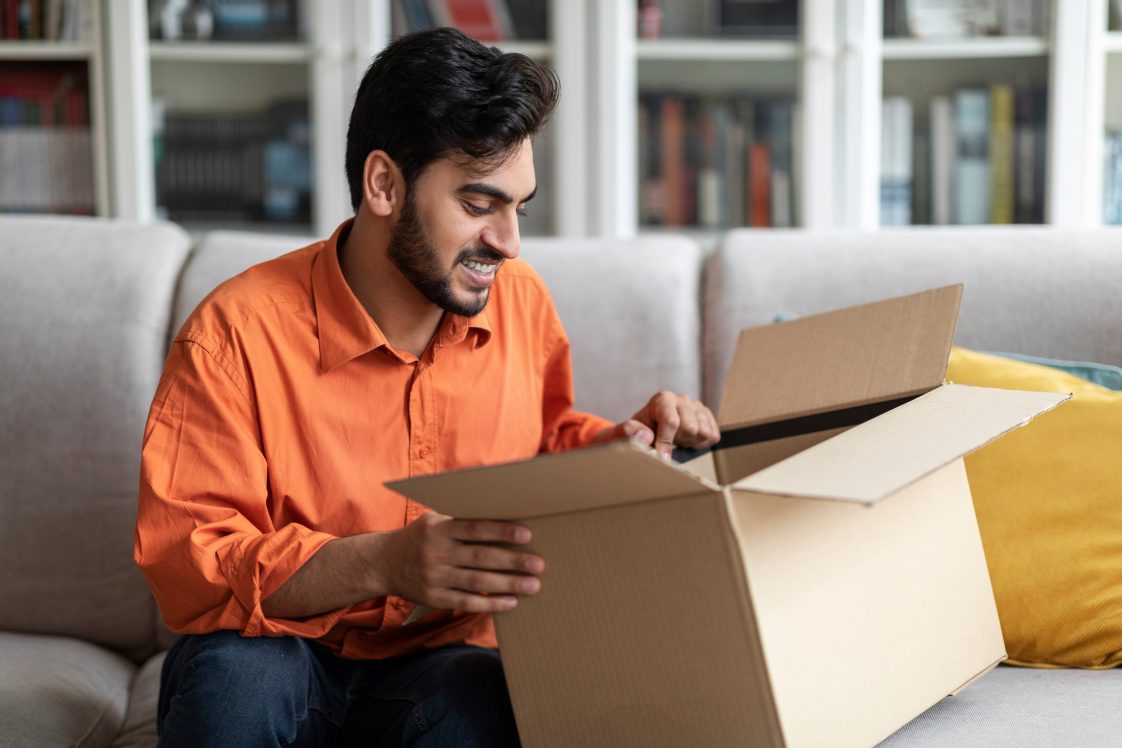 happy man opened up a package that has just been delivered