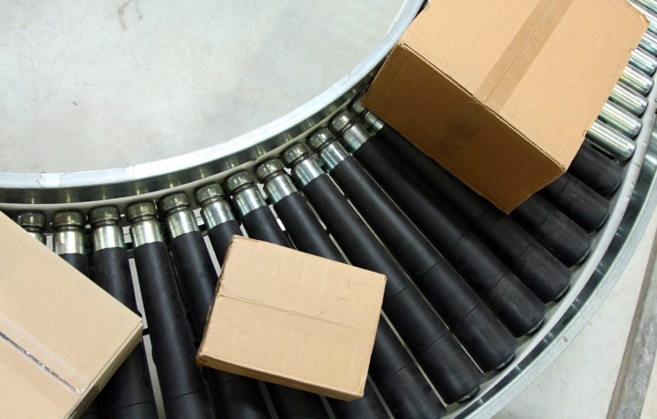 packages on a conveyer belt in radial order fulfillment center